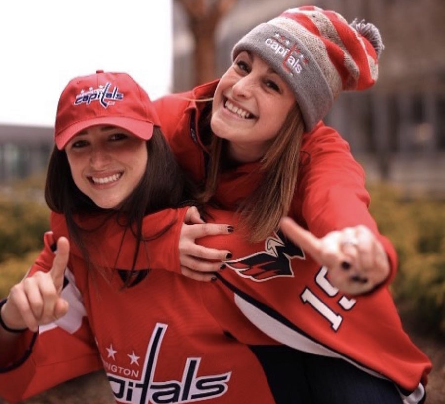 Elizabeth and a colleague in Washington Capitals gear outside Capital One Arena