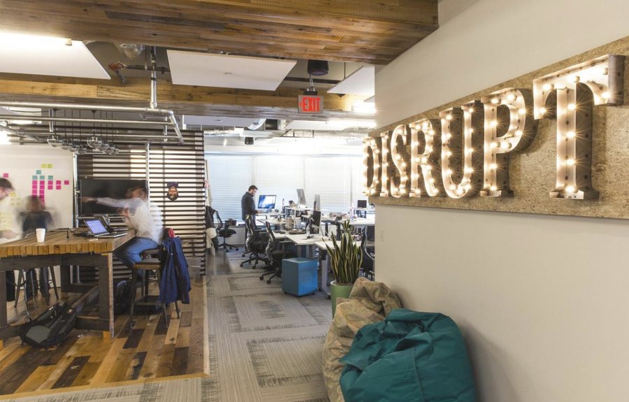 Capital One digital office with a lit marquee sign reading DISRUPT